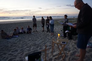 Rector Mike Uptin taking a church service on the beach at Surfers Paradise